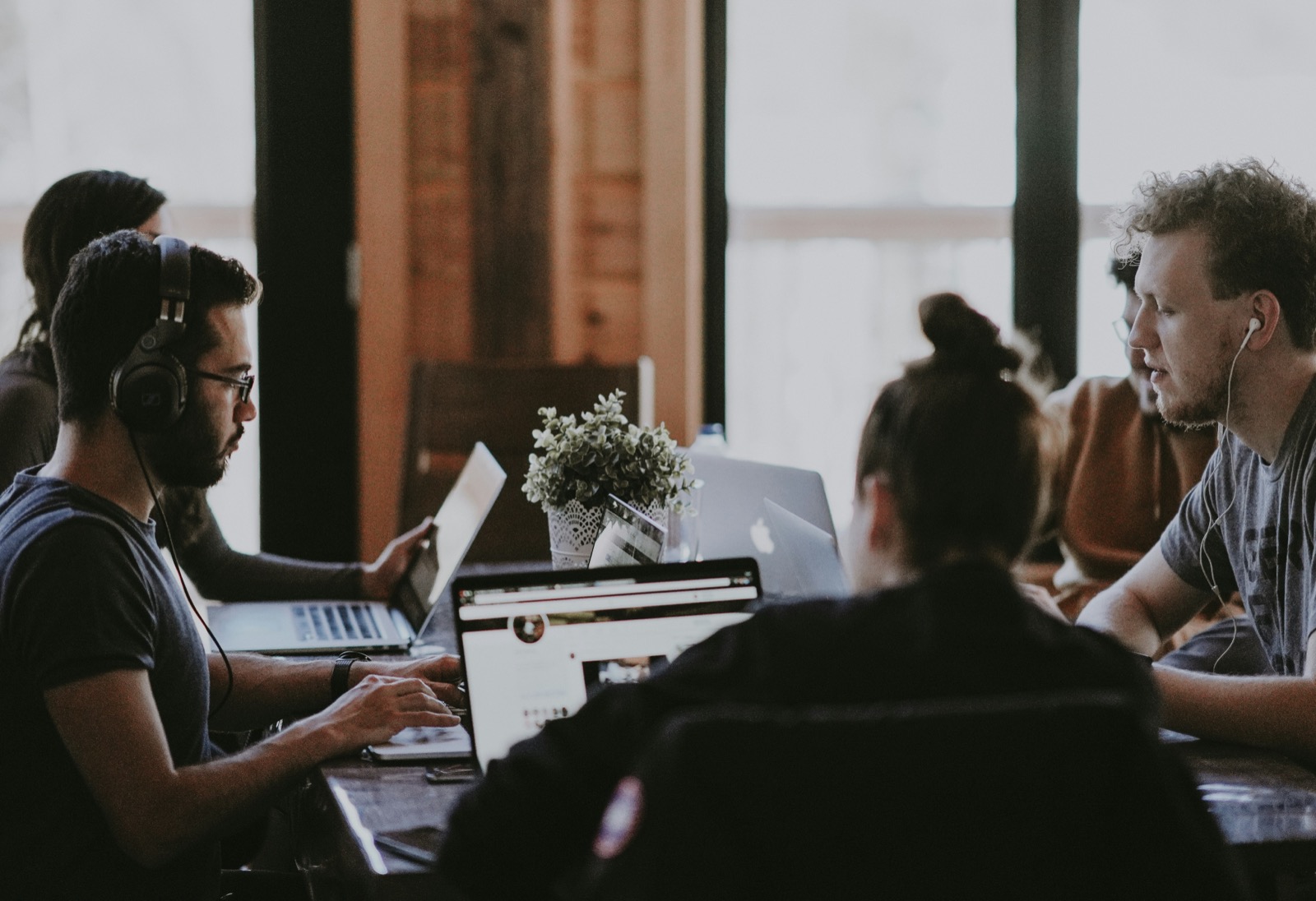 Team collaborating on laptops in a modern workspace